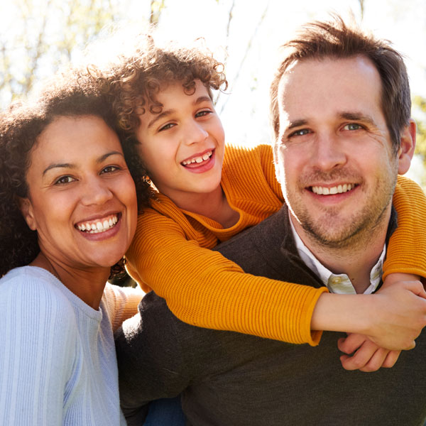 Family smiling together after a visit to Germantown Advanced Dentistry